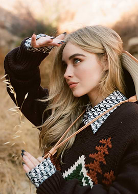Sabrina Carpenter in sweater looking out