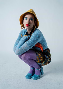 Dua Lipa in Yellow Hat and Blue Outfit