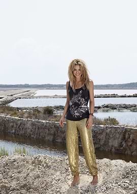 Woman in gold pants by salt flats