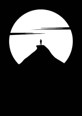 Lone figure on mountain peak at sunset