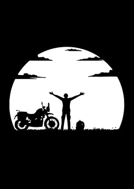 Motorcyclist celebrating at sunset