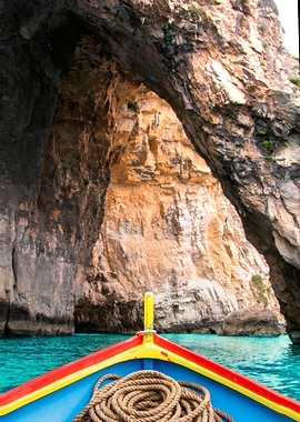 Boat entering the sea cave Blue Grotto in Malta