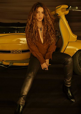 Shakira on a yellow scooter