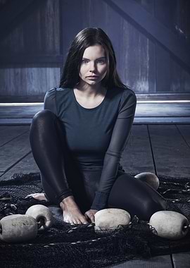 Woman in dark clothing on fishing net