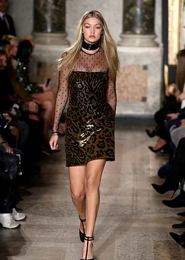 Gigi Hadid walks the runway in a leopard print dress