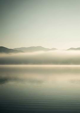 Misty Mountains Over Calm Lake