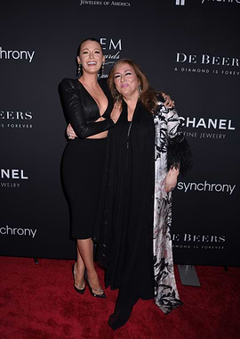 Two women posing on a red carpet