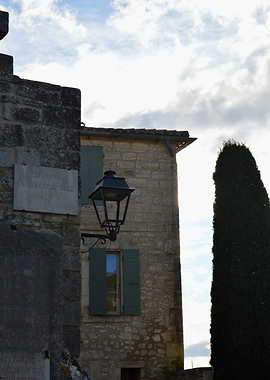 Stone building with lantern and cypress tree