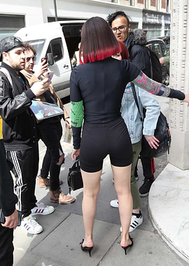 Woman in black outfit with colorful sleeves