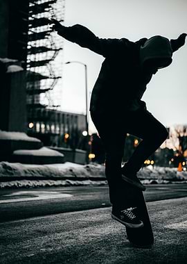 Skateboarder performing a trick at dusk