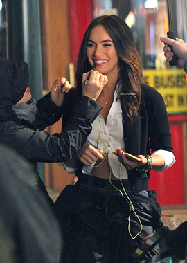 Megan Fox applying lipstick on set