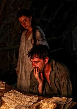 Couple reading old documents by candlelight