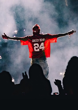 Performer on stage with arms outstretched