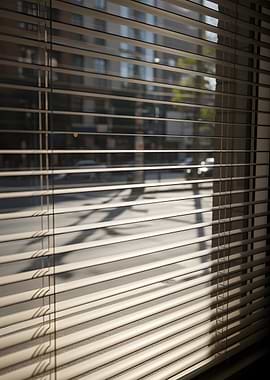 Cityscape seen through blinds