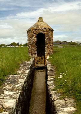 Old stone structure in a grassy field