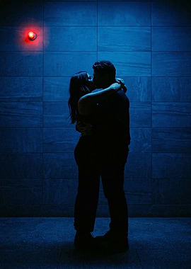 Couple kissing under red light