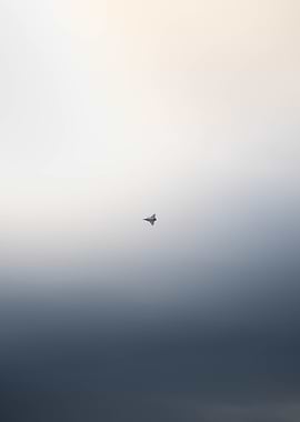 Fighter Jet in a Misty Sky