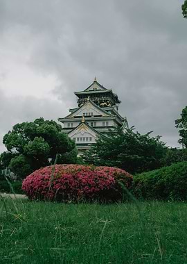 Osaka Castle in Bloom: Pink Azaleas and Overcast Skies