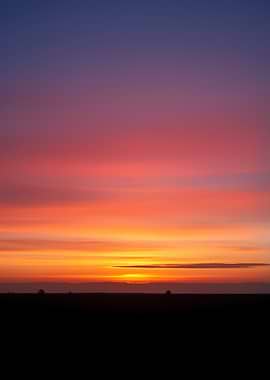 Vibrant Sunset Over a Dark Horizon