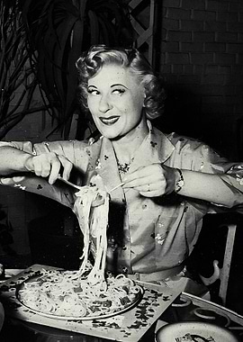 Woman eating spaghetti with chopsticks