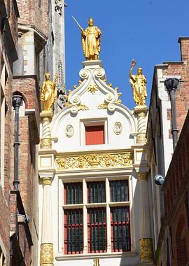 Ornate Golden Statues on Building Facade