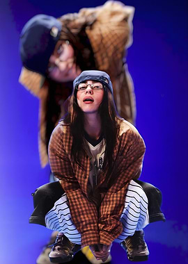 Fashionable Billie Eilish person in plaid shirt and cap
