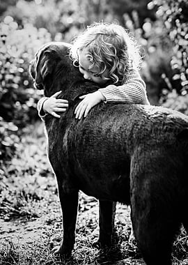 Child hugging a dog