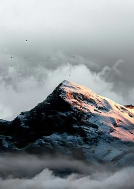 Snow-capped mountain peak at sunrise