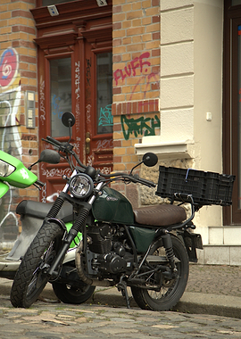 Green Motorcycle Parked by Graffiti Wall