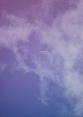 Moon peeking through purple clouds