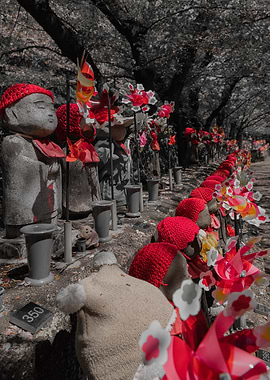 Jizo statues with red hats and pinwheels