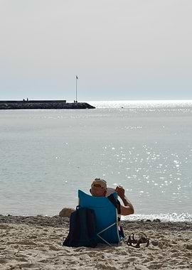 Man Relaxing on Beach by the Sea