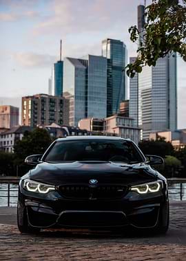 Black BMW M4 in Cityscape