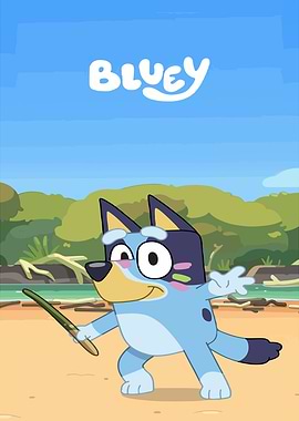 Bluey holding a stick on the beach