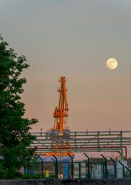 Industrial Crane and Moon at Dusk