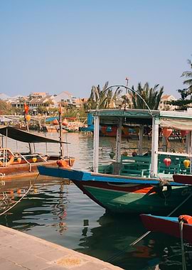 Boats docked in a canal with buildings in background