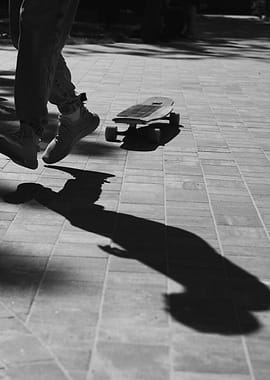 Skateboarder's Shadow on Pavement
