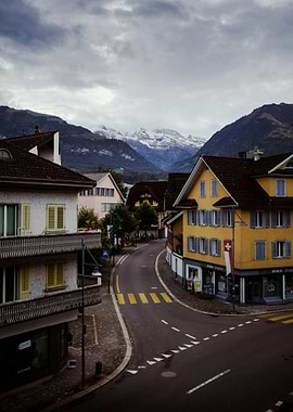 Swiss Village Street with Snow-Capped Mountains