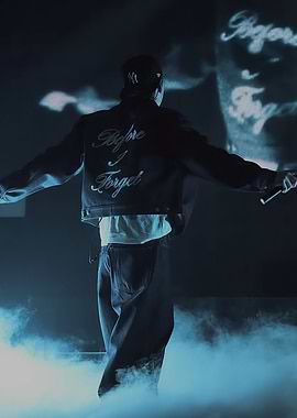 Performer on stage with text on jacket