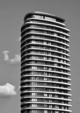 Modern Curved Skyscraper Against Sky