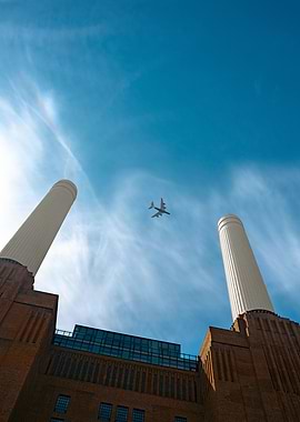 Airplane flying over Battersea Power Station