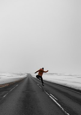 Man jumping on a snowy road