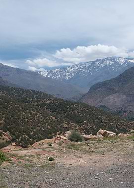 Snow-capped mountains and green hills