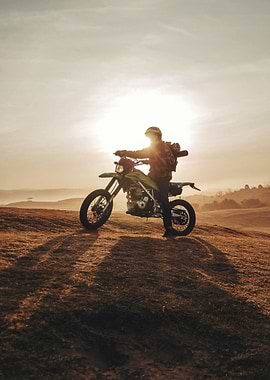 Motorcyclist on a Hilltop at Sunset