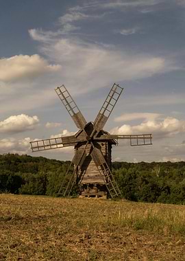 Rustic Wooden Windmill in a Field