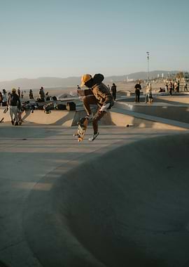 Skateboarder mid-air at sunset
