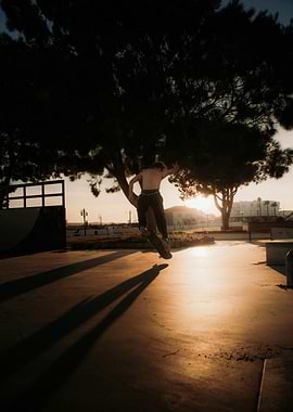 Skateboarder performing a trick at sunset