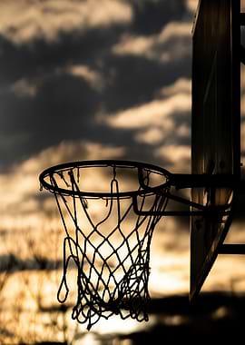 Basketball hoop silhouette at sunset