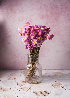 Pink dried flowers in a glass vase