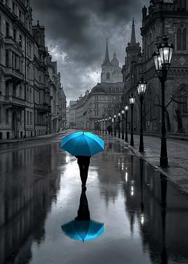 Person with blue umbrella in rainy city